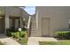 Exterior view showing a stairway to the upper levels and back access door at 165 Durham Pl # 165, Longwood, FL 32779