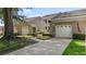 Exterior view featuring attached garages, manicured landscaping, and an inviting walkway at 165 Durham Pl # 165, Longwood, FL 32779