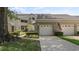 A well-maintained exterior view of a condo with a one-car garage and an American flag at 165 Durham Pl # 165, Longwood, FL 32779