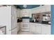 Kitchen featuring white cabinets, white appliances, and a pass through to the dining room at 165 Durham Pl # 165, Longwood, FL 32779