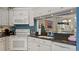 Kitchen with white cabinets, black granite counters, and appliances at 165 Durham Pl # 165, Longwood, FL 32779