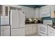 Kitchen featuring white cabinets, black countertops, and stainless appliances at 165 Durham Pl # 165, Longwood, FL 32779