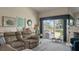 Comfortable living room featuring a large leather sectional and view to the outside patio at 165 Durham Pl # 165, Longwood, FL 32779