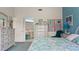 Main bedroom with blue accent wall, adjoining bathroom, and coastal themed decor at 165 Durham Pl # 165, Longwood, FL 32779