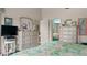 Main bedroom featuring dressers, TV, an ensuite bathroom, and a coastal-themed bedspread at 165 Durham Pl # 165, Longwood, FL 32779