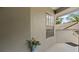 Exterior porch view with neutral stucco wall, tile flooring, and decorative accents at 165 Durham Pl # 165, Longwood, FL 32779
