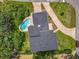 An aerial view of a home with a private pool, brick-paved driveway, and lush greenery at 1850 Lakeshore Cir, Longwood, FL 32750