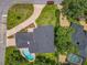 Aerial view of home showing landscaping, roof, pool and driveway at 1850 Lakeshore Cir, Longwood, FL 32750