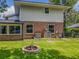 This backyard has an in-ground fire pit, attached sunroom, air conditioning units, and well-kept green grass at 1850 Lakeshore Cir, Longwood, FL 32750