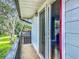 This balcony features views of the neighborhood and the entryway to the home's interior, with an open sliding glass door at 1850 Lakeshore Cir, Longwood, FL 32750