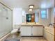 Bathroom with double sinks, tile floors, and a combined tub and shower enclosure at 1850 Lakeshore Cir, Longwood, FL 32750