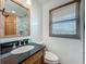 Bathroom featuring a vanity, window, and a partial view of a glass-enclosed shower at 1850 Lakeshore Cir, Longwood, FL 32750