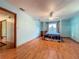 Bedroom featuring hardwood floors, a ceiling fan, and a comfortable four-poster bed at 1850 Lakeshore Cir, Longwood, FL 32750