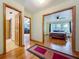 Bedroom showing hardwood floors, closets, and doorway to other bedroom with ceiling fan and window at 1850 Lakeshore Cir, Longwood, FL 32750