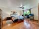 Bedroom with wood floors, a ceiling fan, and a workstation at 1850 Lakeshore Cir, Longwood, FL 32750