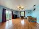 Bedroom with wood floors, ceiling fan, and sliding glass doors to a balcony at 1850 Lakeshore Cir, Longwood, FL 32750