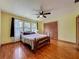 Bedroom featuring hardwood floors, a ceiling fan, a large window, and a spacious closet at 1850 Lakeshore Cir, Longwood, FL 32750