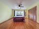 Bedroom featuring hardwood floors, ceiling fan, window, and closet space for plenty of storage at 1850 Lakeshore Cir, Longwood, FL 32750