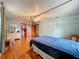 Bright bedroom with hardwood floors, a four-poster bed, closet, and large windows at 1850 Lakeshore Cir, Longwood, FL 32750