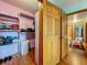 Walk-in closet with shelving, wood floors, and open doors leading to the hallway at 1850 Lakeshore Cir, Longwood, FL 32750