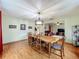 Open dining area with a wooden table, chandelier, and wood-look flooring at 1850 Lakeshore Cir, Longwood, FL 32750