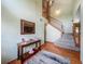 Bright entryway features a staircase, wood floors and a decorative mirror at 1850 Lakeshore Cir, Longwood, FL 32750