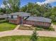 Aerial view of a two-story brick home with mature trees and landscaping at 1850 Lakeshore Cir, Longwood, FL 32750