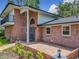 Charming brick home with a distinctive architectural design, landscaping, and brick-paved walkway and patio at 1850 Lakeshore Cir, Longwood, FL 32750