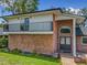 Attractive brick home featuring a balcony, unique arched window above the front door, and a paver walkway at 1850 Lakeshore Cir, Longwood, FL 32750