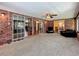 Spacious sunroom with brick walls, windows, carpet floors and sliding glass doors at 1850 Lakeshore Cir, Longwood, FL 32750