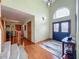 Welcoming foyer with hardwood floors, a staircase, and double door entry at 1850 Lakeshore Cir, Longwood, FL 32750