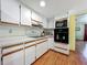 Bright kitchen features stainless steel appliances, ample cabinet space, and wood-look floors at 1850 Lakeshore Cir, Longwood, FL 32750