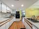 Functional kitchen with white cabinetry, wood-look floors, and a double sink, perfect for cooking at 1850 Lakeshore Cir, Longwood, FL 32750