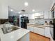 Bright kitchen with white countertops, stainless steel sink and appliances, and ample cabinet space at 1850 Lakeshore Cir, Longwood, FL 32750