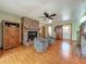 A living room with hardwood floors, brick fireplace and two patterned chairs at 1850 Lakeshore Cir, Longwood, FL 32750