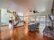 The well-designed living room flows into the kitchen with access to the sunroom, featuring hardwood floors at 1850 Lakeshore Cir, Longwood, FL 32750