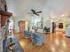 Open concept living room featuring a fireplace, hardwood floors, and easy access to the kitchen at 1850 Lakeshore Cir, Longwood, FL 32750
