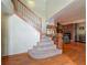 Carpeted staircase leads to a living room with brick fireplace and wood floors at 1850 Lakeshore Cir, Longwood, FL 32750