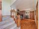 Staircase leads to a living room with brick fireplace and a ceiling fan at 1850 Lakeshore Cir, Longwood, FL 32750