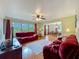 Living room with wood floors, a ceiling fan, and large windows, creating a bright and airy space at 1850 Lakeshore Cir, Longwood, FL 32750