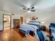 Comfortable main bedroom with wood floors, ceiling fan, a bed, and a desk with a computer at 1850 Lakeshore Cir, Longwood, FL 32750
