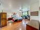 Spacious main bedroom with wood floors, a fan, a bed, and a desk with a computer set up at 1850 Lakeshore Cir, Longwood, FL 32750