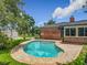 Backyard pool surrounded by a brick paver deck at 1850 Lakeshore Cir, Longwood, FL 32750