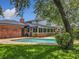 Beautiful backyard with a private pool, brick patio, and a sunroom addition to the brick house at 1850 Lakeshore Cir, Longwood, FL 32750