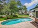A private backyard features a fenced-in pool, lush green grass, and views of the neighbor's houses at 1850 Lakeshore Cir, Longwood, FL 32750