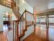 A staircase features hardwood floors, with a carpeted runner and wooden railings leading to the second floor at 1850 Lakeshore Cir, Longwood, FL 32750