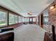 Bright sun room with brick walls, multiple windows and carpet perfect for relaxation and entertaining at 1850 Lakeshore Cir, Longwood, FL 32750