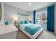 Comfortable bedroom with large window, teal bedding accents, and ample natural light at 1898 Walnut Creek Dr, Kissimmee, FL 34744