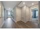 Spacious hallway featuring modern wood flooring, leading to bedrooms and the foyer with ample natural light at 1902 Walnut Creek Dr, Kissimmee, FL 34744