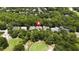 Aerial view highlighting the location surrounded by a golf course, trees and other homes at 207 Spalding Way, Deland, FL 32724